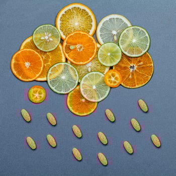 Citrus fruit slices and vitamin C pills photo