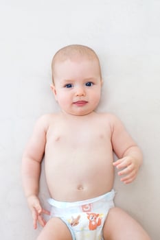Cute baby girl lying on bed photo
