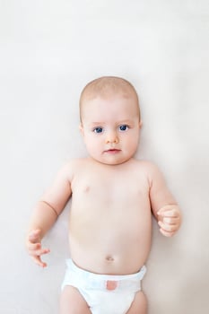 Cute baby girl lying on bed photo