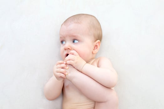 Cute baby girl lying on bed photo