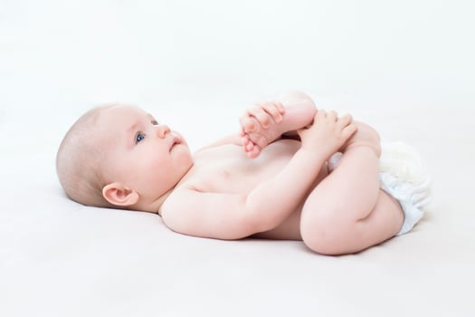 Cute baby girl lying on bed photo