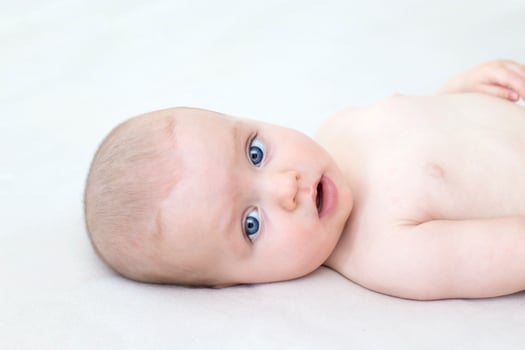 Cute baby girl lying on bed photo