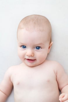 Cute baby girl lying on bed photo