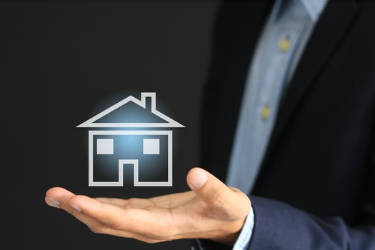 Concept image of businessman and symbol of house or property insurance photo