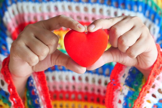 Woman holding a red heart close-up photo
