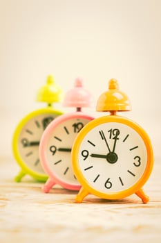 Alarm clocks on a wooden desk photo