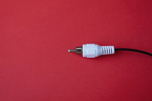 A cable plug connection on a red background photo