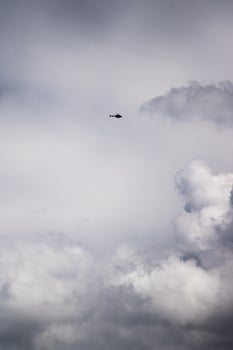 Helicopter flying in clouds photo