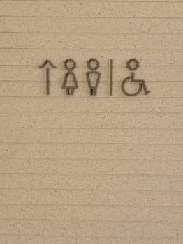 Restroom symbol on brown background photo
