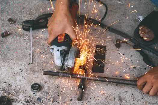 The mechanic is cutting steel photo