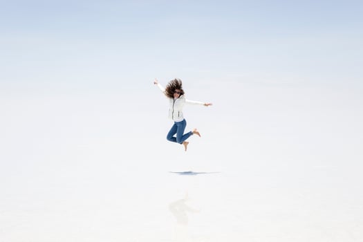 Young woman at Salar de uyuni salt flat in Bolivia photo