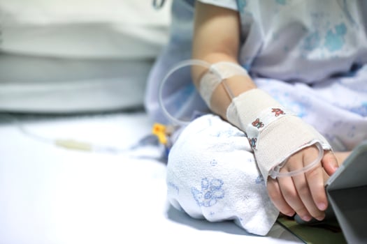 Sick child on a receiving a saline solution in hospital photo