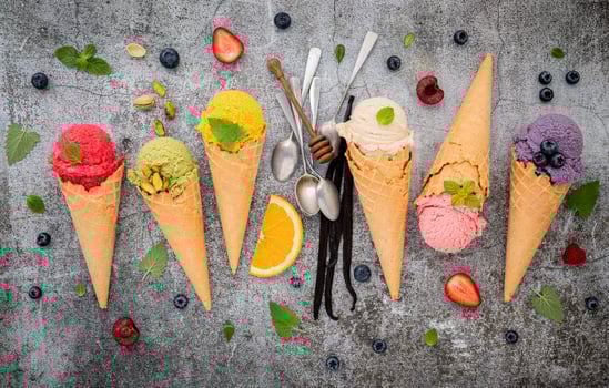 Colorful ice cream in cones on a concrete background photo