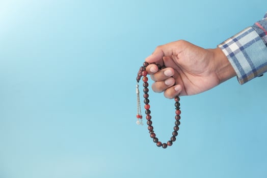 Prayer beads on blue background photo