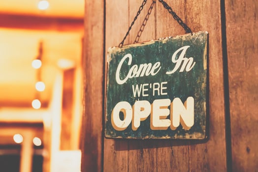 A business sign that says open on door at entrance photo