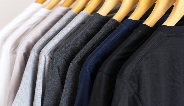 Close up of t-shirts on hangers, apparel background photo