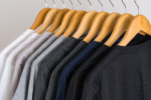 Close up of t-shirts on hangers, apparel background photo