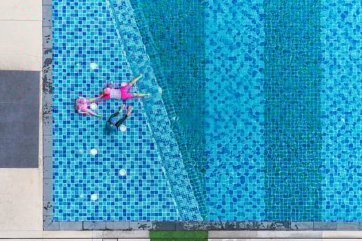 Children playing in the pool, Aerial top view photo