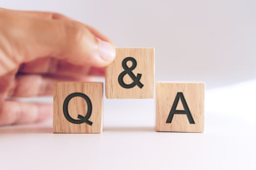 Q and A alphabet on wooden cubes in hand photo
