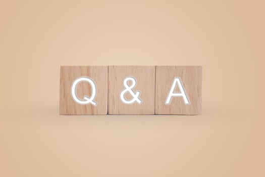 Q and A alphabet on wooden cubes with background photo