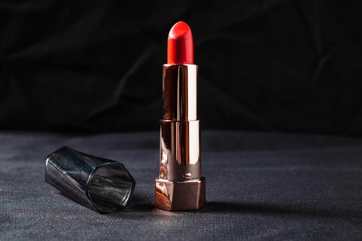 Tube of lipstick on a black cloth photo