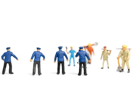 Miniature police and an angry mob on a white background photo