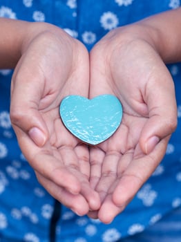 Blue heart in hands photo