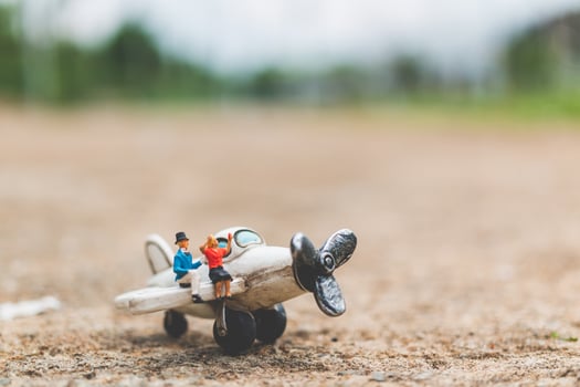Miniature couple sitting on an airplane, exploring the world concept photo