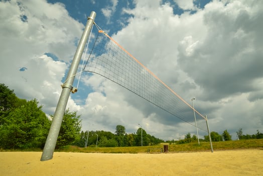 Volleyball net and sandy court in a park photo