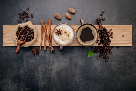 Cups of coffee with coffee beans and flavors photo