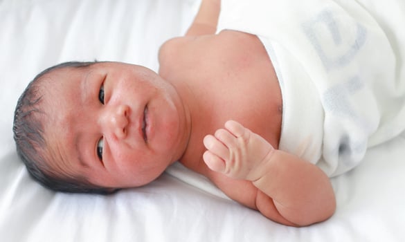 Male newborn baby on a hospital bed photo