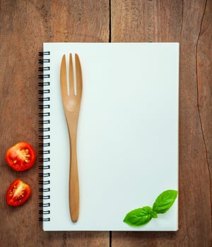 Notebook mock-up with tomatoes and basil photo