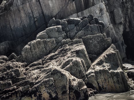 Rocks with straight edges at low tide of a beach on the Asturian coast photo