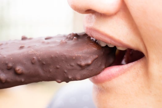 Woman eating a chocolate bar photo
