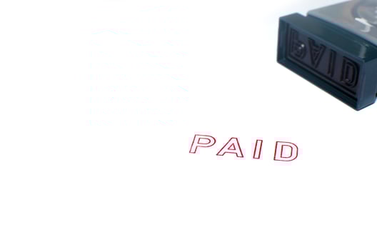 Paid stamp on white photo