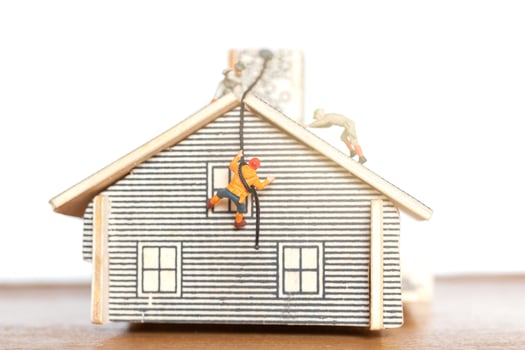 Miniature people staying at home doing self-quarantine, stay at home concept photo