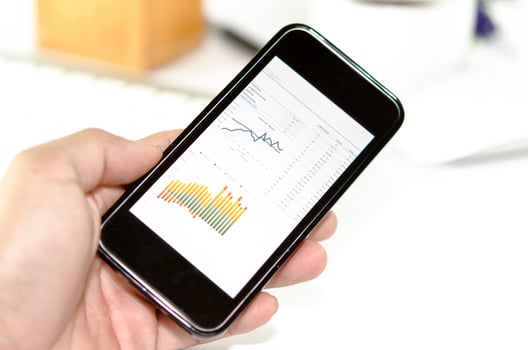 Graphs on a smartphone in hand photo