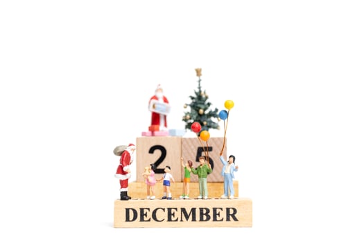 Miniature Santa Claus holding gifts for a happy family with the date December 25 on a white background photo