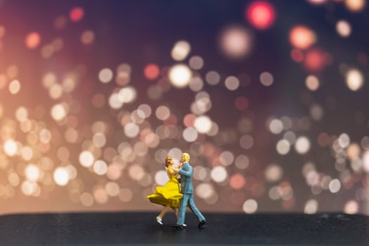 Miniature couple dancing with a bokeh background, Valentine's Day concept photo