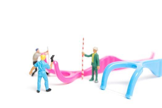 Miniature team working on dental floss isolated on a white background, dental clinic concept photo