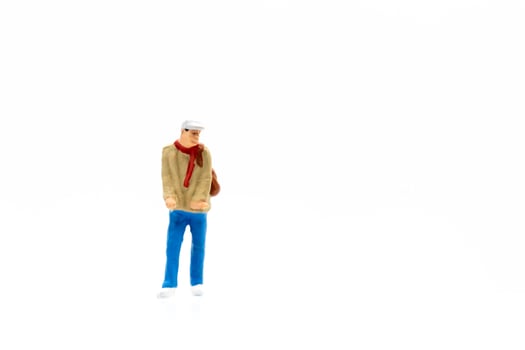 Miniature person standing on a white background photo