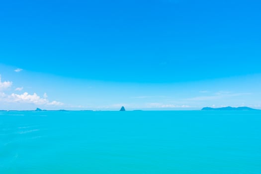 Beautiful ocean with clouds on blue sky photo