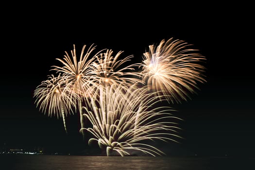Gold fireworks over water photo