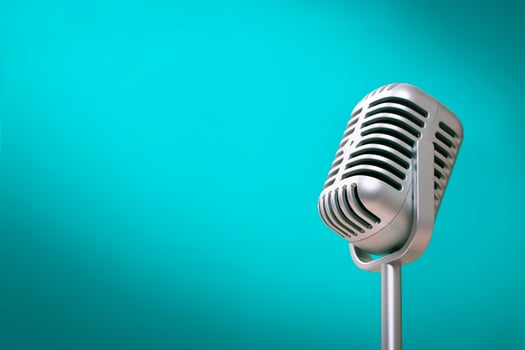 Retro style microphone on green background photo