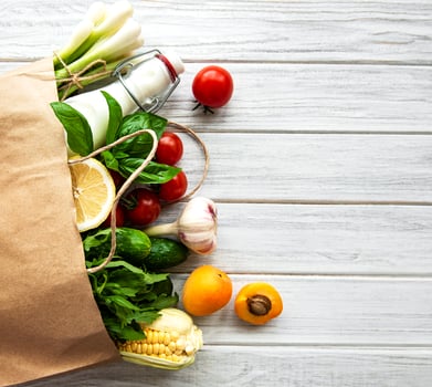 Healthy food in paper bag, vegetables and fruits photo