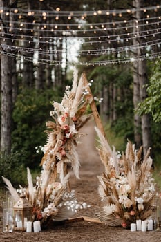 Wedding ceremony area with dried flowers in a meadow in a pine forest photo