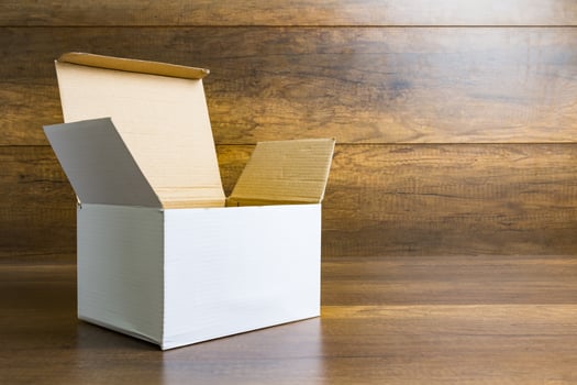 White paper box on a wooden table background photo