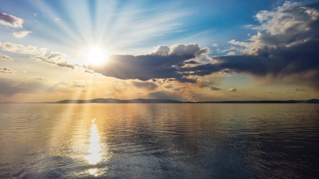 Seascape with colorful cloudy sky over a body of water photo