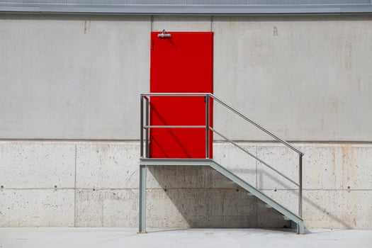 Red metallic door on a white wall photo