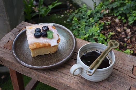 Coffee with a piece of cake on wooden table photo
